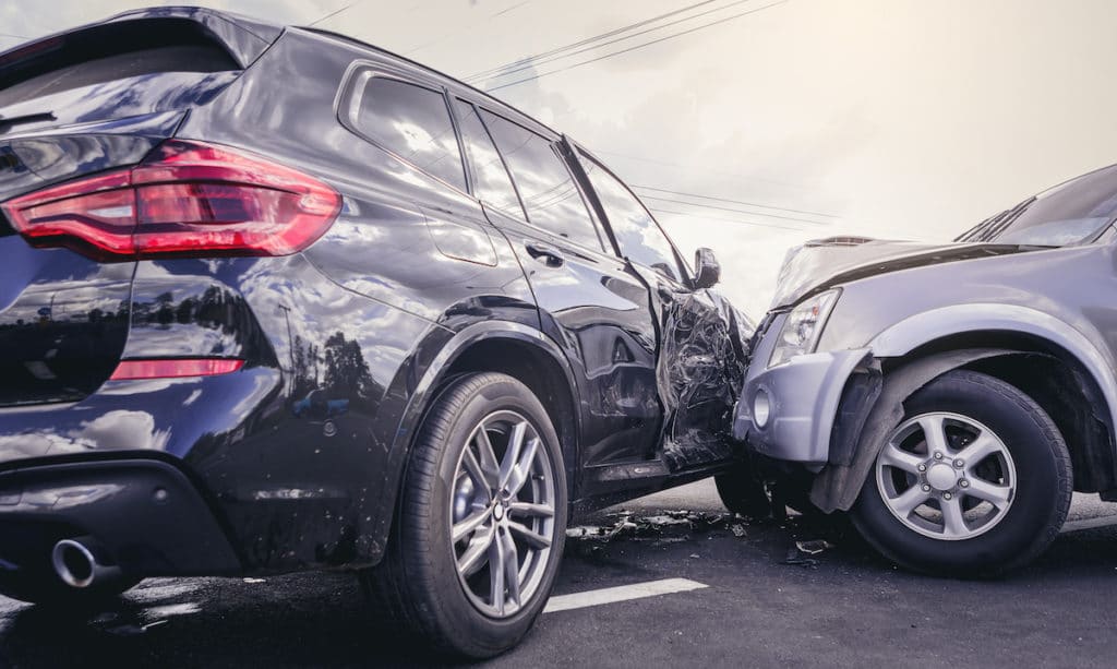 Car crash dangerous accident on the road. SUV car crashing beside another one on the road.